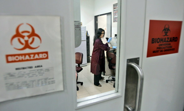A scientist works at the U.S. Naval Medical Research in Jakarta, Indonesia