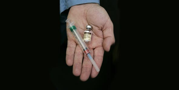 hand holding Gardasil vaccine